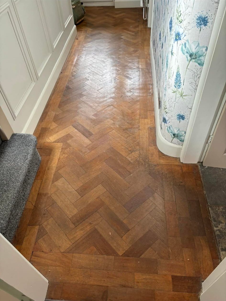 Narrow herringbone hallway with floral wallpaper, before restoration