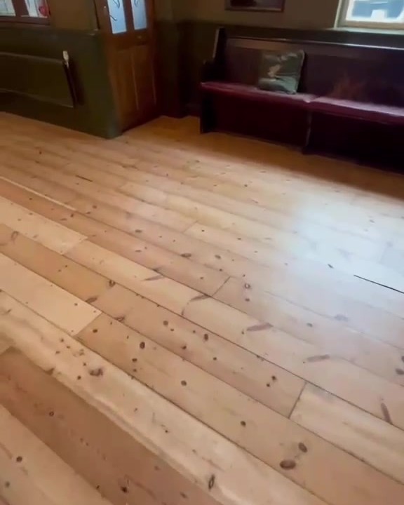 Pine floorboards in a pub style room after sanding and refinishing