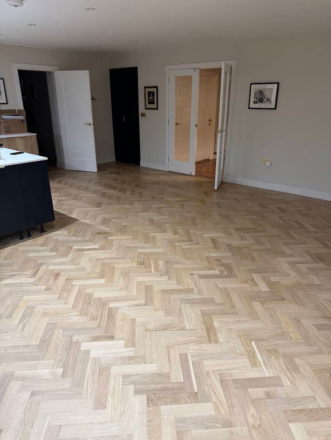 Restored herringbone wooden floor across a kitchen and dining area, from Adrian S.'s job