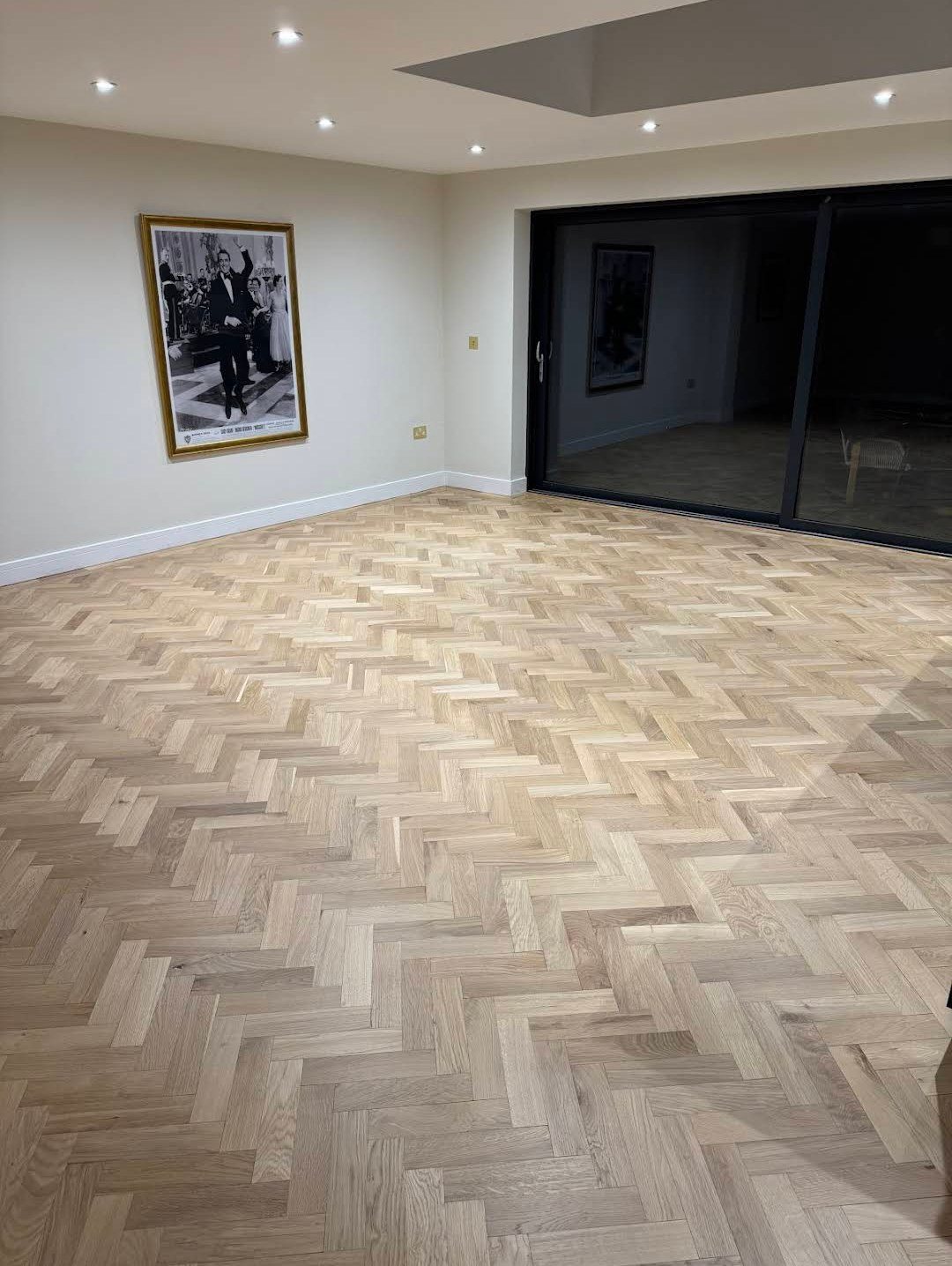 Restored herringbone wooden floor seen from the other end of the room, from Adrian S.'s job
