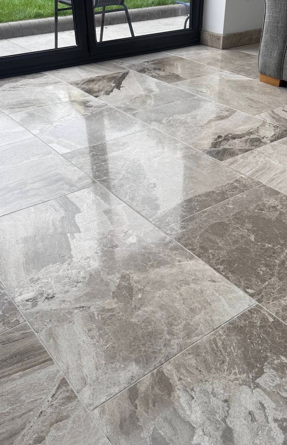 Polished stone tile floor by glass doors, from Emma S.'s job