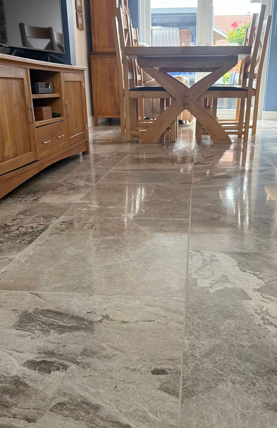 Polished stone tile floor in a dining area, from Emma S.'s job